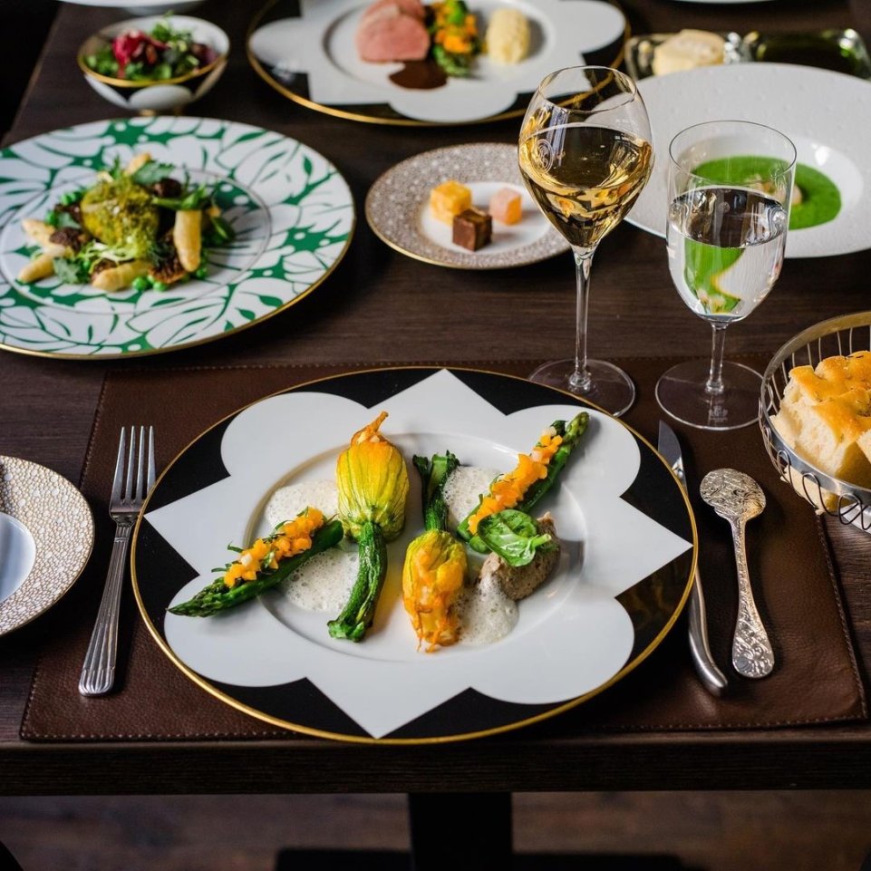 Eleganter Tisch mit kunstvoll angerichteten Gourmetgerichten auf edlem Porzellan. Fürstenberg Porzellan.