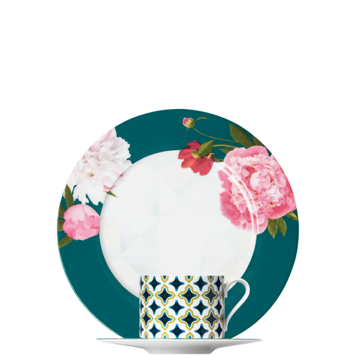 Teller mit Blumenmuster, Tasse mit geometrischem Muster, beides auf schwarzem Hintergrund. Fürstenberg Porzellan.