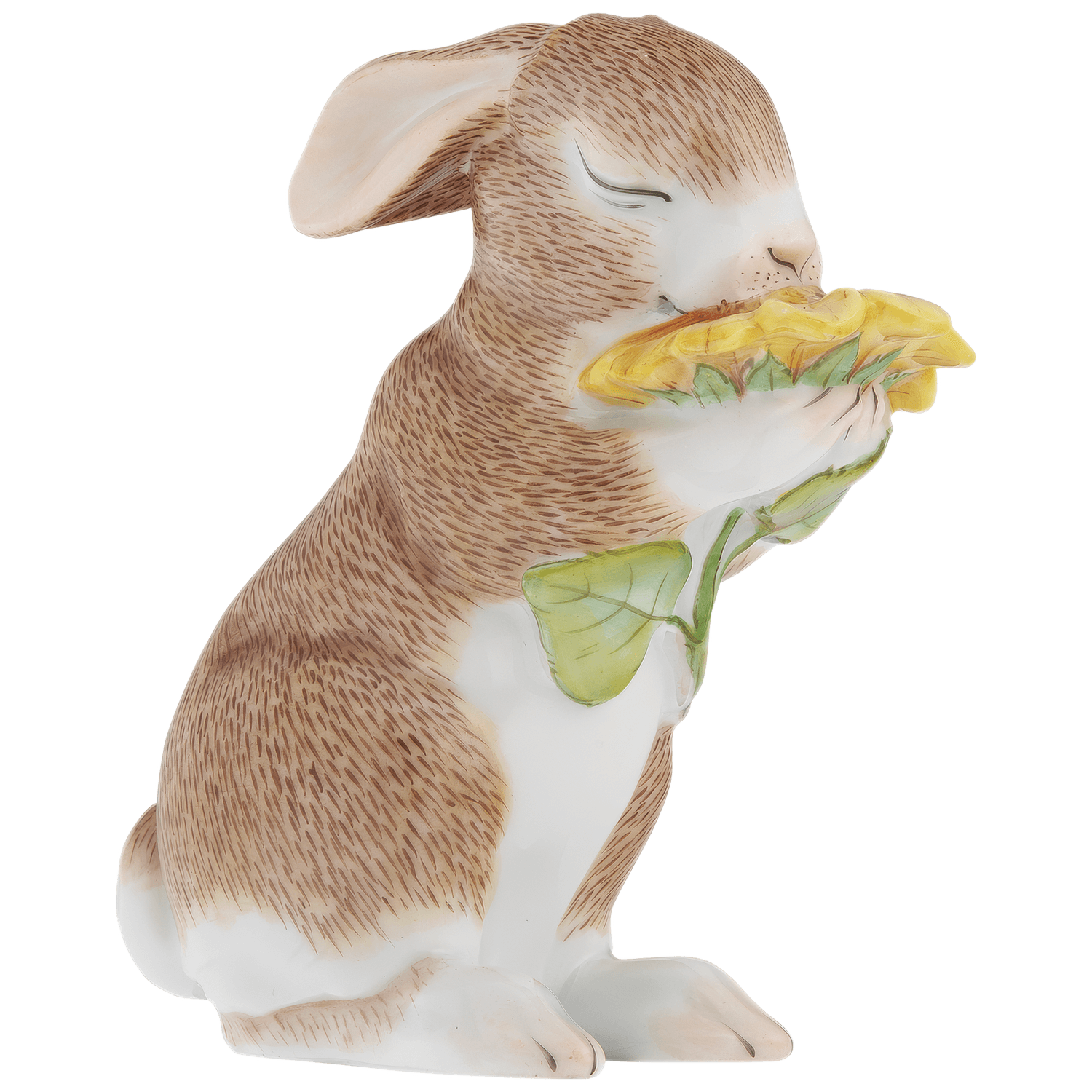 Hase hält gelbe Sonnenblume in beiden Pfoten, aufrecht sitzend. Fürstenberg Porzellan.